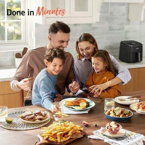 Family enjoying a meal with an air fryer in the kitchen.