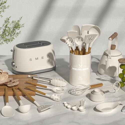 A collection of kitchen appliances and utensils on a marble countertop, including a toaster, kettle, and various cooking tools.