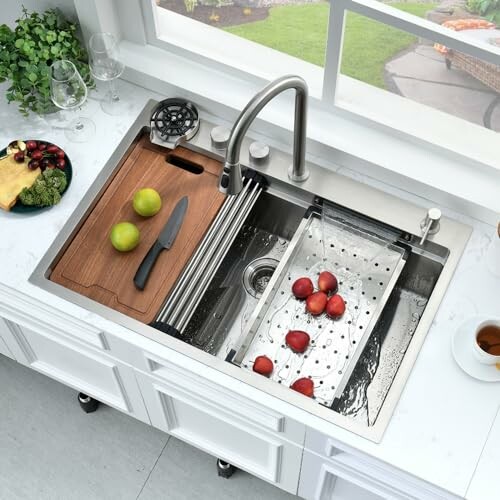 Modern kitchen sink with cutting board, knife, and apples.