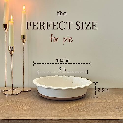 White pie dish with dimensions 10.5 inches wide, 9 inches inner diameter, 2.5 inches deep, next to lit candles.