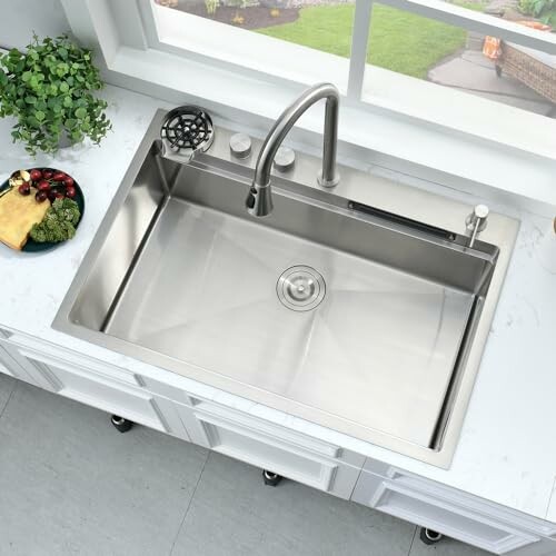 Overhead view of a stainless steel kitchen sink with faucet